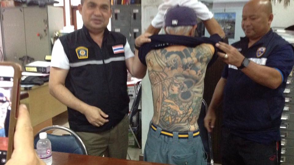 A photo released by Thai police shows Shirai revealing his tattoos. Photo: FM91BKK

