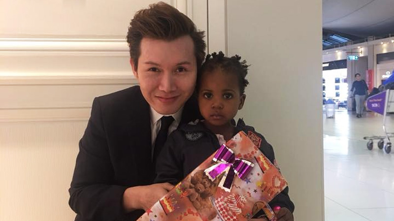 An airport employee posted this viral photo of himself with a gift for one of the airport detainees. Photo: Kanaruj Artt Pornspolt/ Facebook