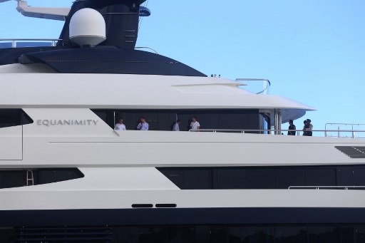 People are seen on deck after Indonesian officials boarded the luxury yacht ‘Equanimity’, reportedly worth some 250 million USD and owned by Jho Low, a former unofficial adviser to the Malaysian fund 1MDB, at Benoa Bay in Bali on February 28, 2018. A luxury yacht sought by US authorities was seized February 28 off the Indonesian tourist island of Bali, officials said, with the vessel reportedly linked to a corruption scandal at Malaysia’s state investment fund. AFP PHOTO: AFP / Rully Prasetyo