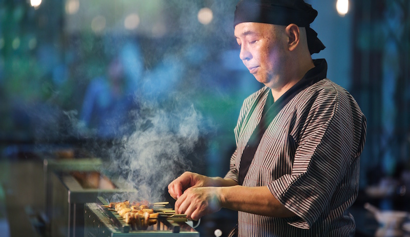 Chef grilling the skewers