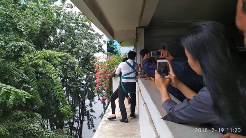 Video screengrab showing an Indonesian police officer grabbing a suicidal woman to safety.