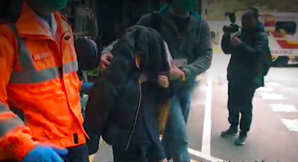 An 11-year-old girl surnamed Wu is taken to hospital after her parents were arrested on suspicion of child abuse. Screengrab via Apple Daily video.