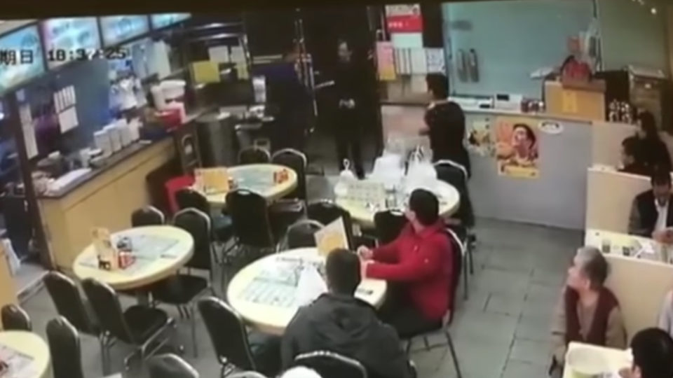 The suspect can be seen raising the blade towards the arm of the victim in this still taken from CCTV footage of the incident