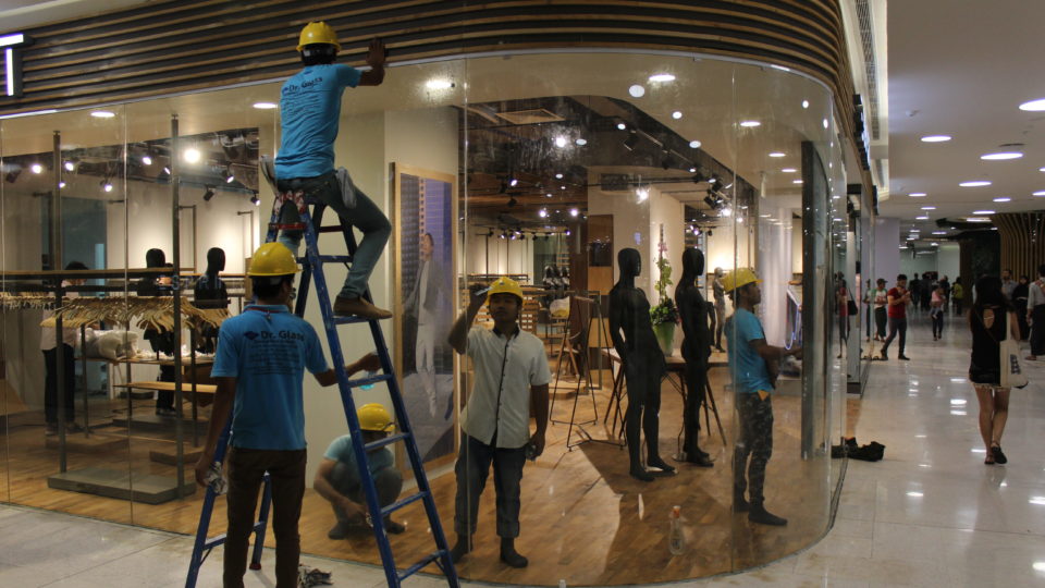 Construction workers work on a shop in Yangon’s Junction City mall on its opening day on March 27, 2017. Photo: Jacob Goldberg