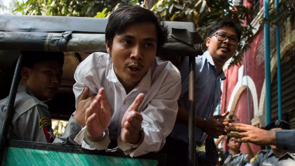 Detained Reuters journalists Kyaw Soe Oo and Wa Lone talk to the media as they are taken from court in Yangon, Myanmar on Feb. 14, 2018. / Ye Aung Thu / AFP /