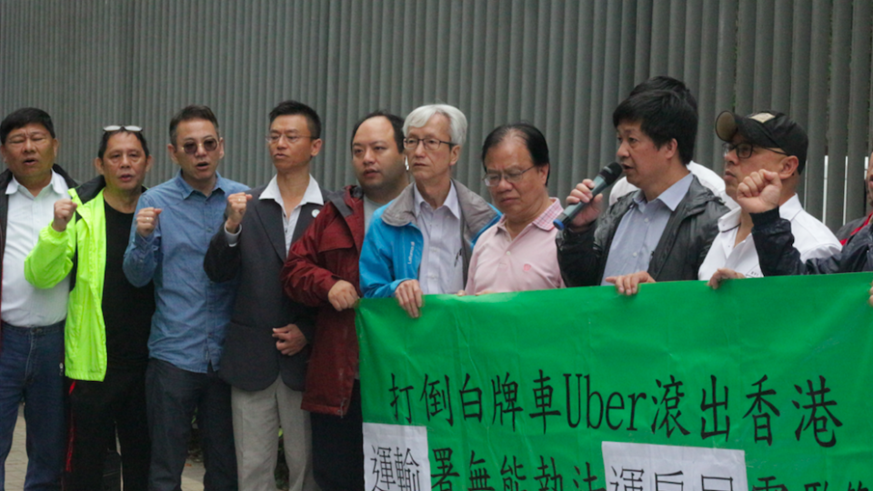 An alliance of taxi drivers chanting “down with Uber”. Photo by Vicky Wong.