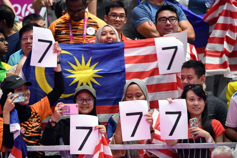 Malaysian spectators shout for Lee Chong Wei as he plays against India’s Srikanth Kidambi in their men’s badminton final at the 2018 Gold Coast Commonwealth Games on the Gold Coast on April 15, 2018. / AFP PHOTO / Saeed KHAN