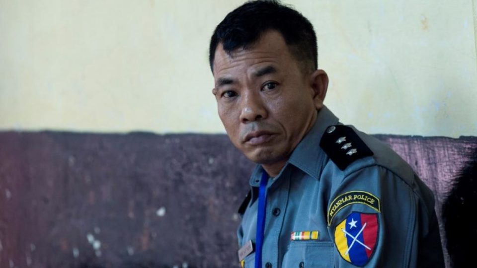 Police Captain Moe Yan Naing waits outside the courthouse before attending the ongoing trial of two detained journalists in Yangon on April 20, 2018. Photo: AFP