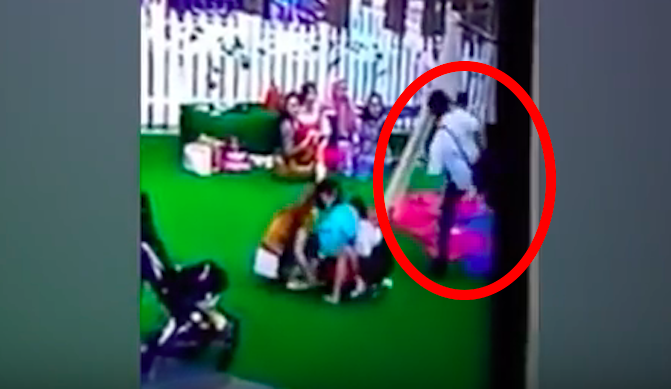 Video screengrab from a CCTV recording taken from Jakarta’ Mal Kelapa Gading on April 25, 2018 showing a man “using his foot” to stop a boy on a swing.