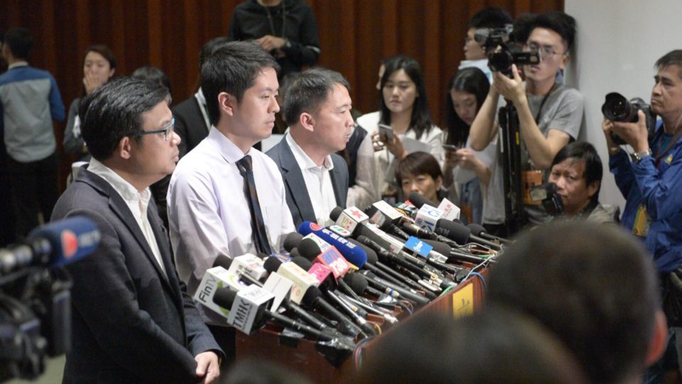 Ted Hui (second from left) speaks to the media following the phone snatching incident. Photo via Facebook.