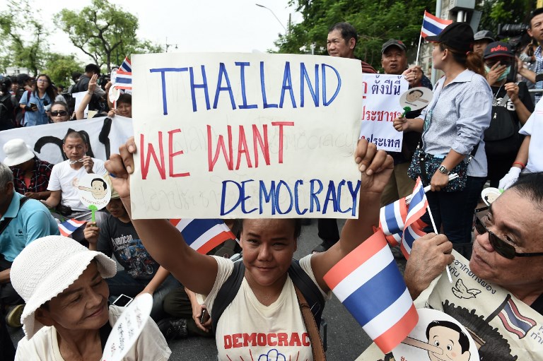 Demonstrators gather near a police barricade outside Thammasat University during a protest to mark the fourth year of junta rule in Bangkok on May 22, 2018. Photo: AFP