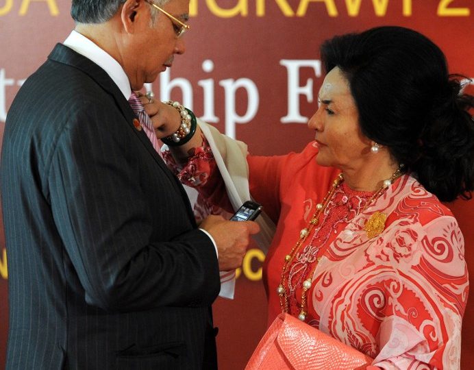 Former Malaysian first lady Rosmah Mansor adjusts the tie of ex-Prime Minister Najib Razak before the opening ceremony of the Langkawi International Dialogue 2011 in Putrajaya on June 19, 2011. AFP PHOTO / Saeed Khan