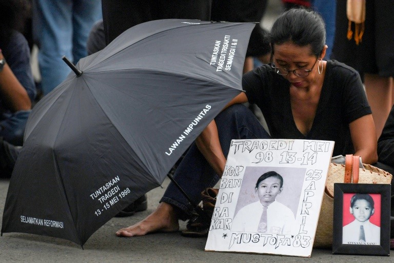 An activist attends a rally outside the presidential palace in Jakarta, demanding justice for their children’s deaths AFP / MADEIRA