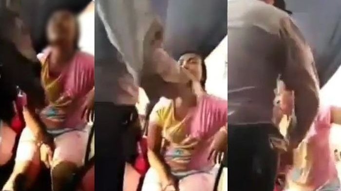 Screengrab from a viral video showing a cop in Indonesia slapping his niece.