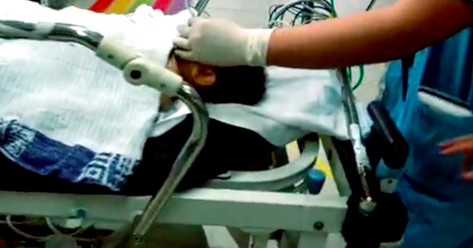 Doctor giving an 8-month-old baby boy oxygen at the hospital shortly after the accident. Screengrab via Apple Daily.