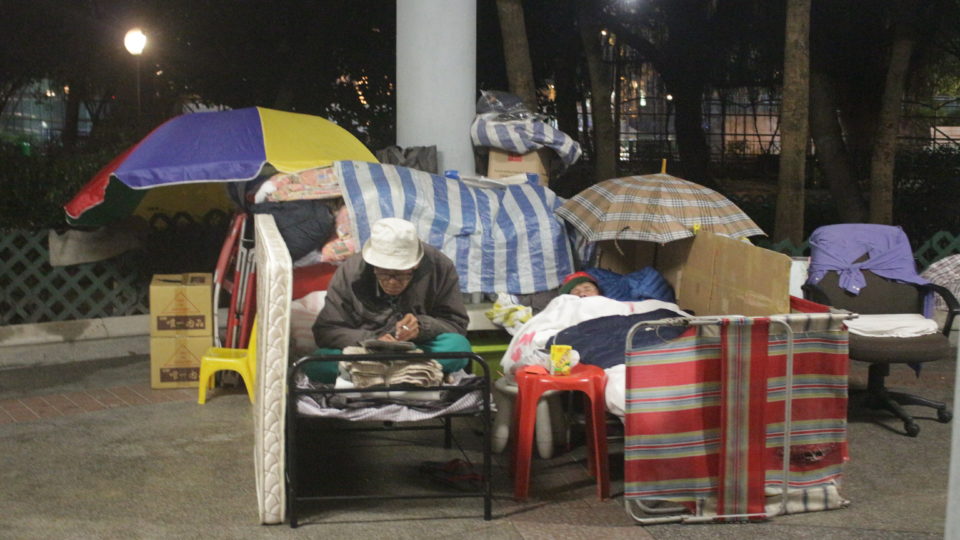 Two men taking shelter under a canopy in Tung Chau Street Park in Tai Kok Tsui. Photo by Vicky Wong.