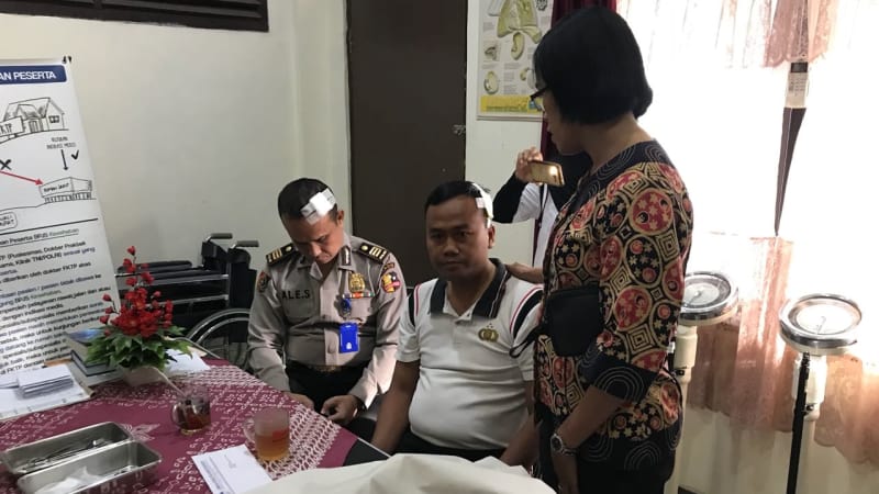 Two of Grand Commissioner Ekotrio Budhiniar’s victims after having had their injuries nursed. Photo: Istimewa