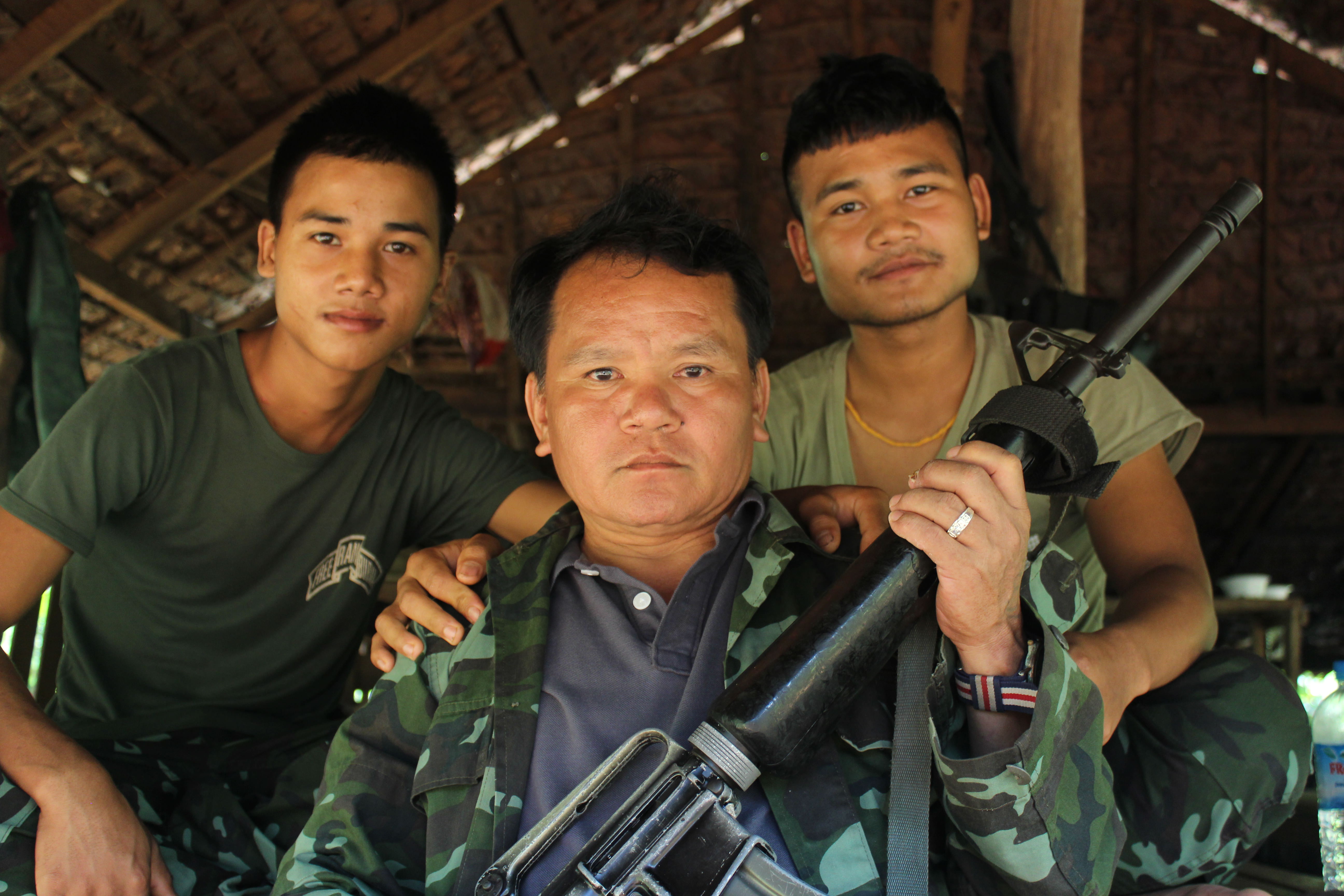 Arrow, center, poses with two of his 10 subordinates at the Kyaung Ma Hmu fort in Nov. 2017. He led the small base in Kawkareik Township for five years until his death in early June 2018. Photo: Jacob Goldberg
