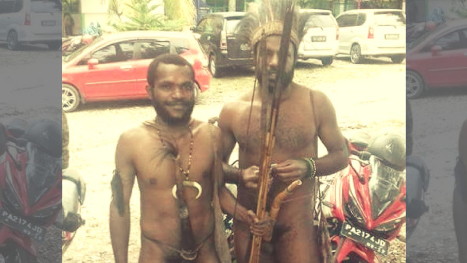 Albertus Yatipai and Yan Elopere, two students from Jayapura’s Science and Techology University (USTJ) wearing traditional outfits including koteka.