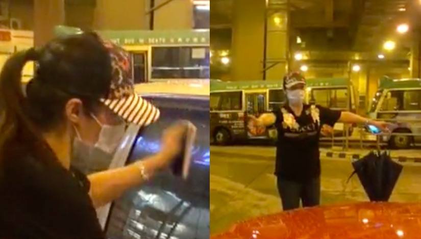 The theft victim, surnamed Siu, demonstrates how she tried to stop a taxi getting away with her belongings. Screengrab via Apple Daily.
