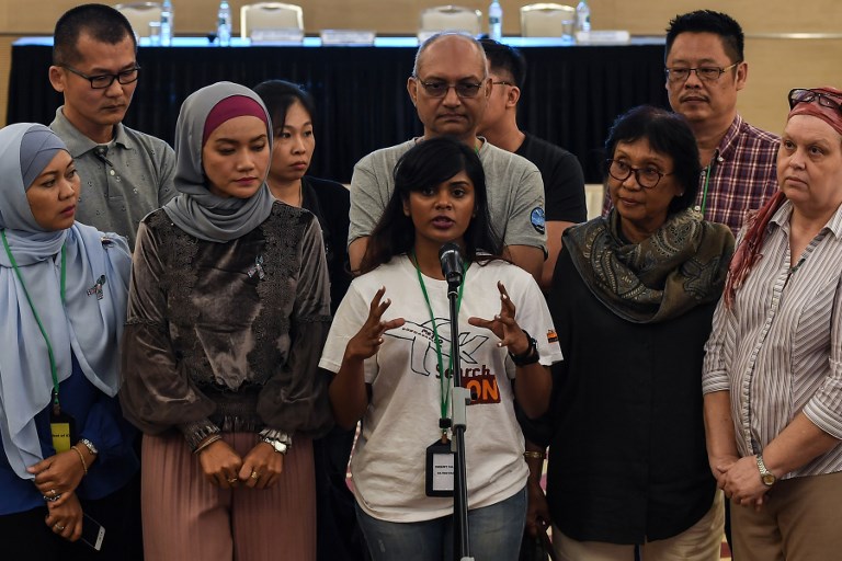 Grace Subathirai Nathan (C), daughter of missing Malaysia Airlines flight MH370 passenger Anne Daisy, speaks during a press conference after being presented with the final investigation report on the missing flight, in Putrajaya, outside Kuala Lumpur, on July 30, 2018.Relatives of people aboard Flight MH370 said on July 30 they hoped a long-awaited report into the plane's disappearance might give them answers about one of the world's most enduring aviation mysteries. / AFP PHOTO / Mohd RASFAN