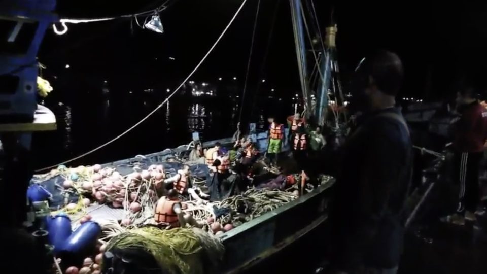 Passengers sit on the deck of a fishing boat that rescued them after their ship capsized near Phuket in Thailand. Screen Grab