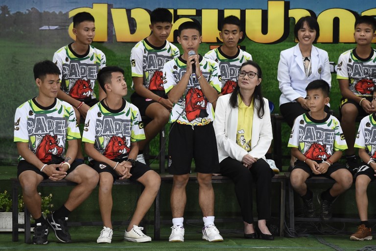 Adul Sam-on (C), one of the twelve boys dramatically rescued from deep inside a Thai cave after being trapped for more than a fortnight, speaks during a press conference in Chiang Rai on July 18, 2018. Photo: AFP