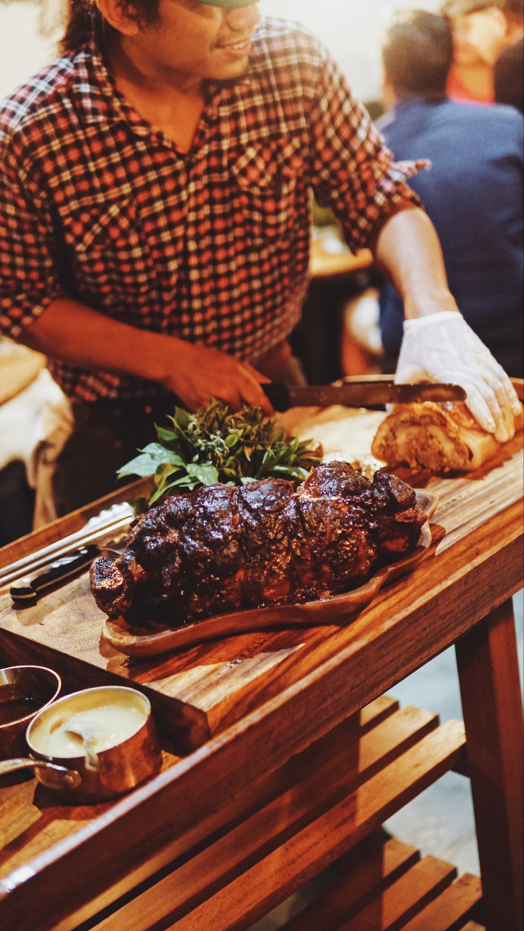 Kasida, the Locavore To Go chef slicing into the porchetta. Photo: Coconuts Bali