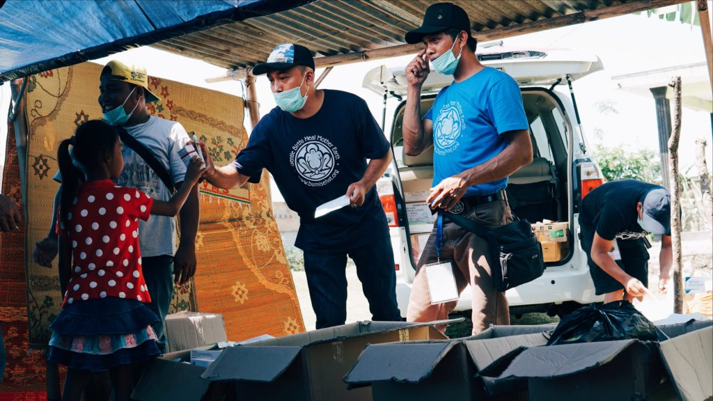 Bumi Sehat volunteers pass out medical supplies to evacuees after their medical check-ups. Photo: Coconuts Bali