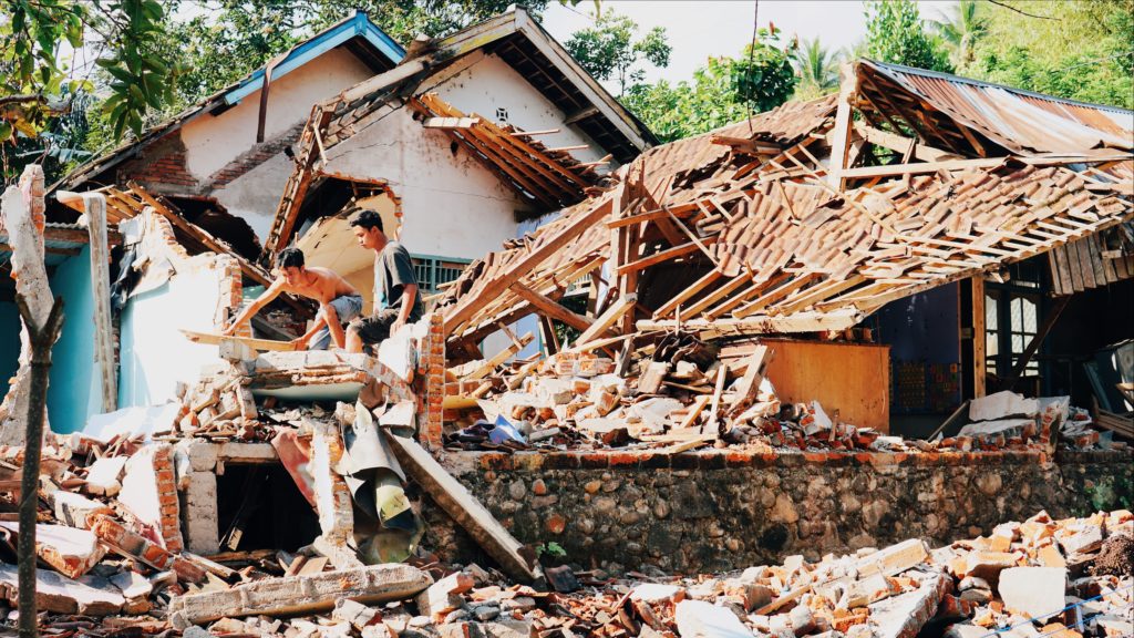 Villagers dismantle what’s left of a house in Gunung Sari, West Lombok. It will have to be fully torn down before it can be rebuilt. Photo: Coconuts Bali