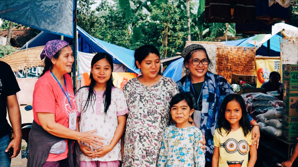 Robin Lim (left) and Bumi Sehat senior midwife Budi (far right) meet with a couple of pregnant women who they plan to help care for in Gunung Sari, West Lombok. Photo: Coconuts Bali