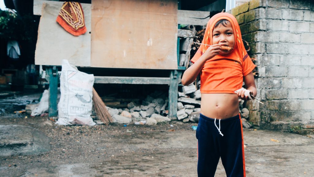 Like most kids in this village, a boy in West Embungpas is covered in an itchy rash, probably from lack of access to clean water. 