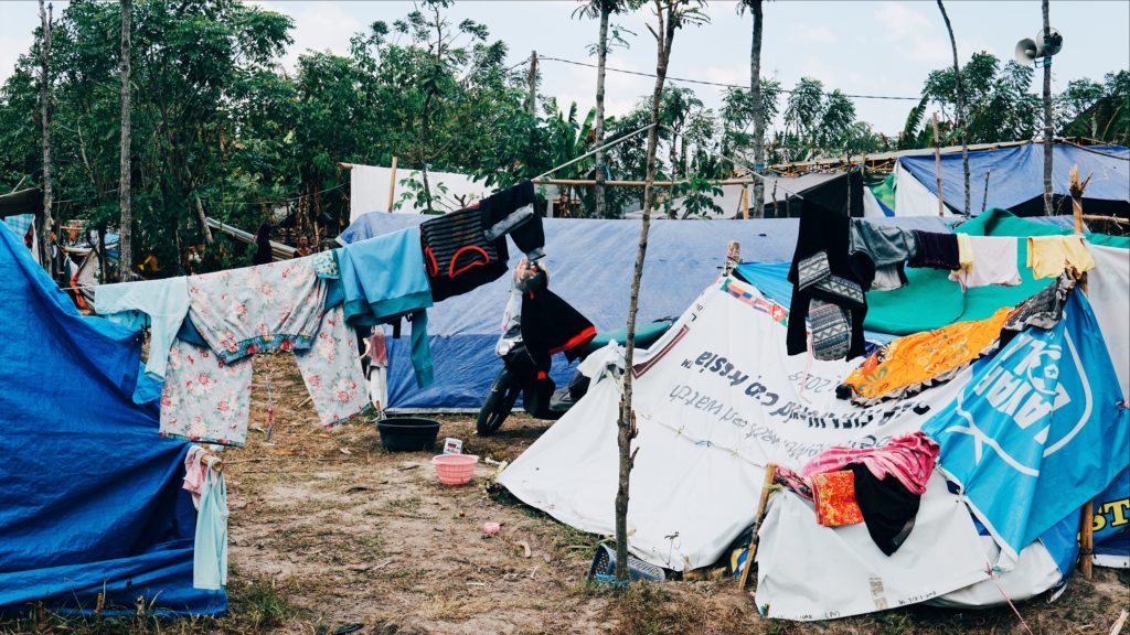 Plastic ad banners have become a useful material for making tents. Photo: Coconuts Bali