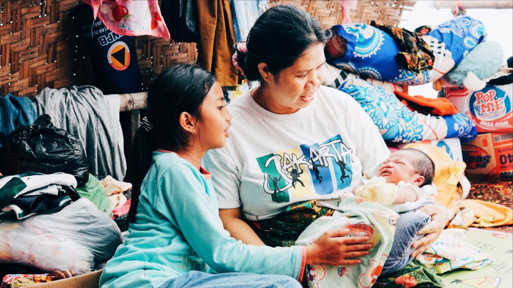 Janah and her 10-year-old daughter look on with love at Baby Z. Photo: Coconuts Bali