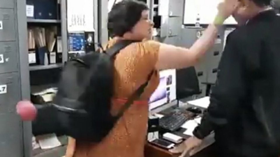 Auj-e Taqaddas pictured slapping an Immigration officer in Bali in July 2018. Image from viral footage via @lambe_turah