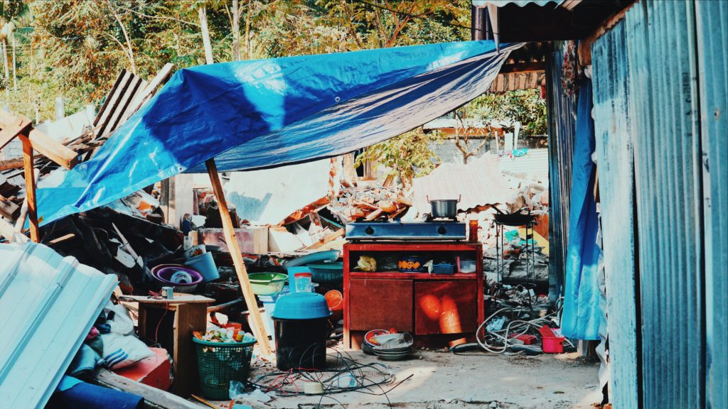 A makeshift kitchen at an evacuation camp surrounded by wreckage in Gunung Sari, West Lombok. Photo: Coconuts Bali