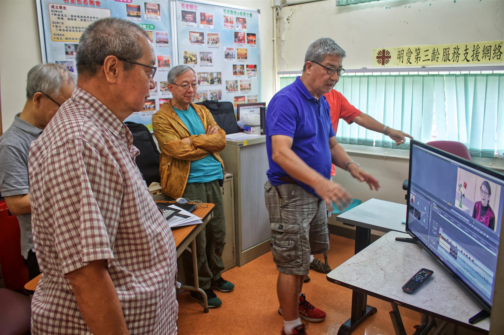 Ng Kwok-hung (in blue) instructs his team on video editing software. Picture: Vicky Wong