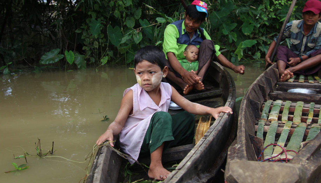 A family waits to enter the home of Daw Aye Than to receive publicly donated disaster relief aid on Aug. 2, 2018. Photo: Jacob Goldberg