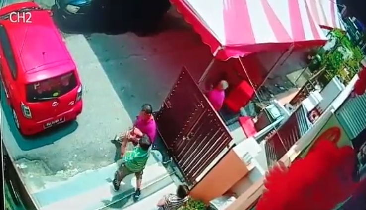 Slap attack: Screencap of CCTV footage of two neighbors fighting over a gate