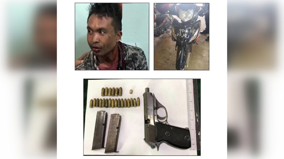 Suspect Khun Kaw Lar (aka Maung Myo), his motorbike, and the gun found in his possession. Photo: MOI