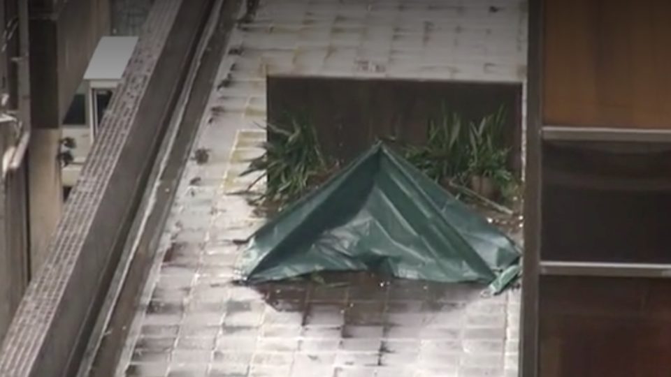 A picture of a police tent covering the body of the man who jumped from a building in Sheung Wan this morning. Via Apple Daily.