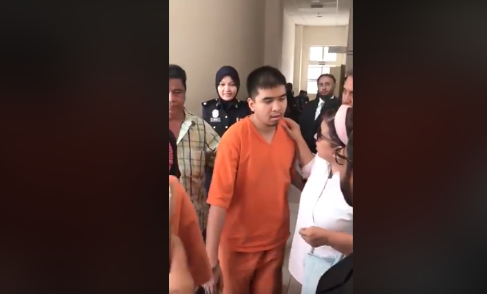 Ahmad, being led into court 