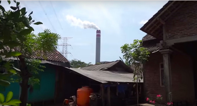 A steam tower pokes out over a village in Jepara, Central Java. Photo: Greenpeace Indonesia