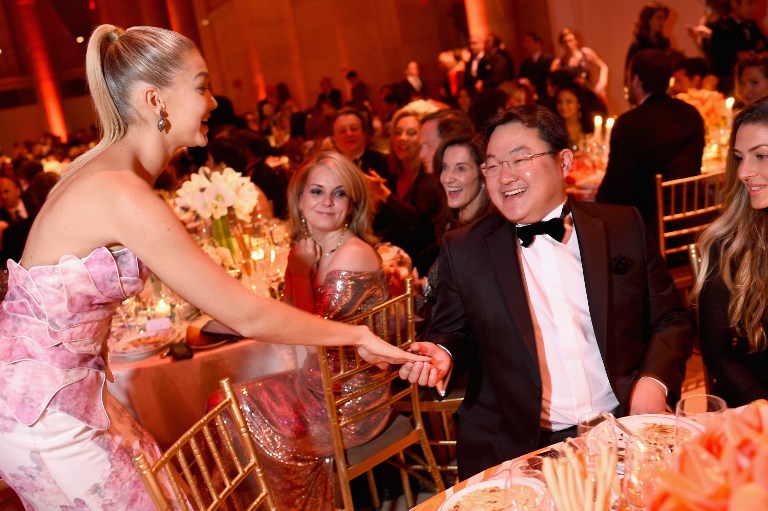 Gigi Hadid greets Jho Low at the Angel Ball charity event hosted by Gabrielle’s Angel Foundation at Cipriani Wall Street on October 20, 2014 in New York City.   Dimitrios Kambouris/Getty Images for Gabrielle’s Angel Foundation/AFP