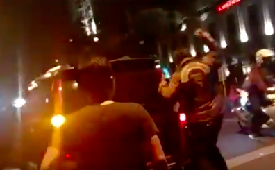 A member of a motorcycle community in Bandung beating up a car driver following a collision. Photo: Video screengrab from Twitter