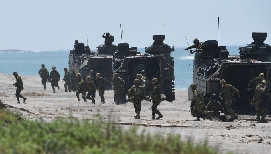 Japanese Ground Home Defense Forces disembark from their amphibious assault vehicles during an amphibious landing exercise at the beach of the Philippine Navy training center facing the South China Sea in San Antonio town, Zambales province, north of Manila on October 6, 2018, as they join the annual joint US-Philippine Marines exercises. AFP PHOTO / Ted Aljibe