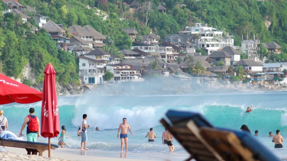 Chinese tourists frolic at Bali’s Dreamland Beach. Photo: Coconuts Bali