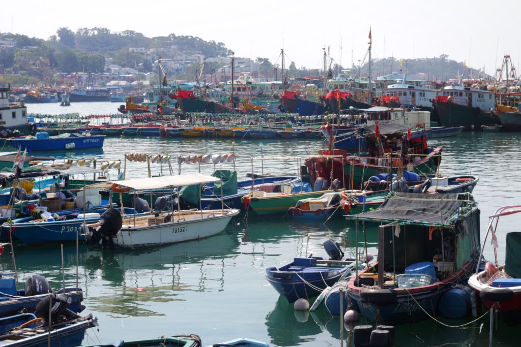 Watch the sunset over the fishing boats parked by the Cheung Chau seafront. Photo by Vicky Wong.