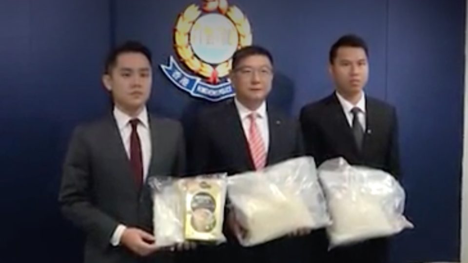 Anti-drug police celebrating their massive bust the best way they know how: getting photographed holding big bags of drugs. Screengrab via Apple Daily video.