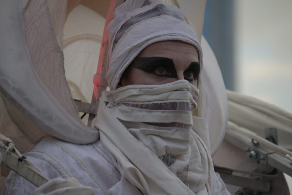 One of the people on stilts walking around festival as bird dinosaur. Photo by Vicky Wong